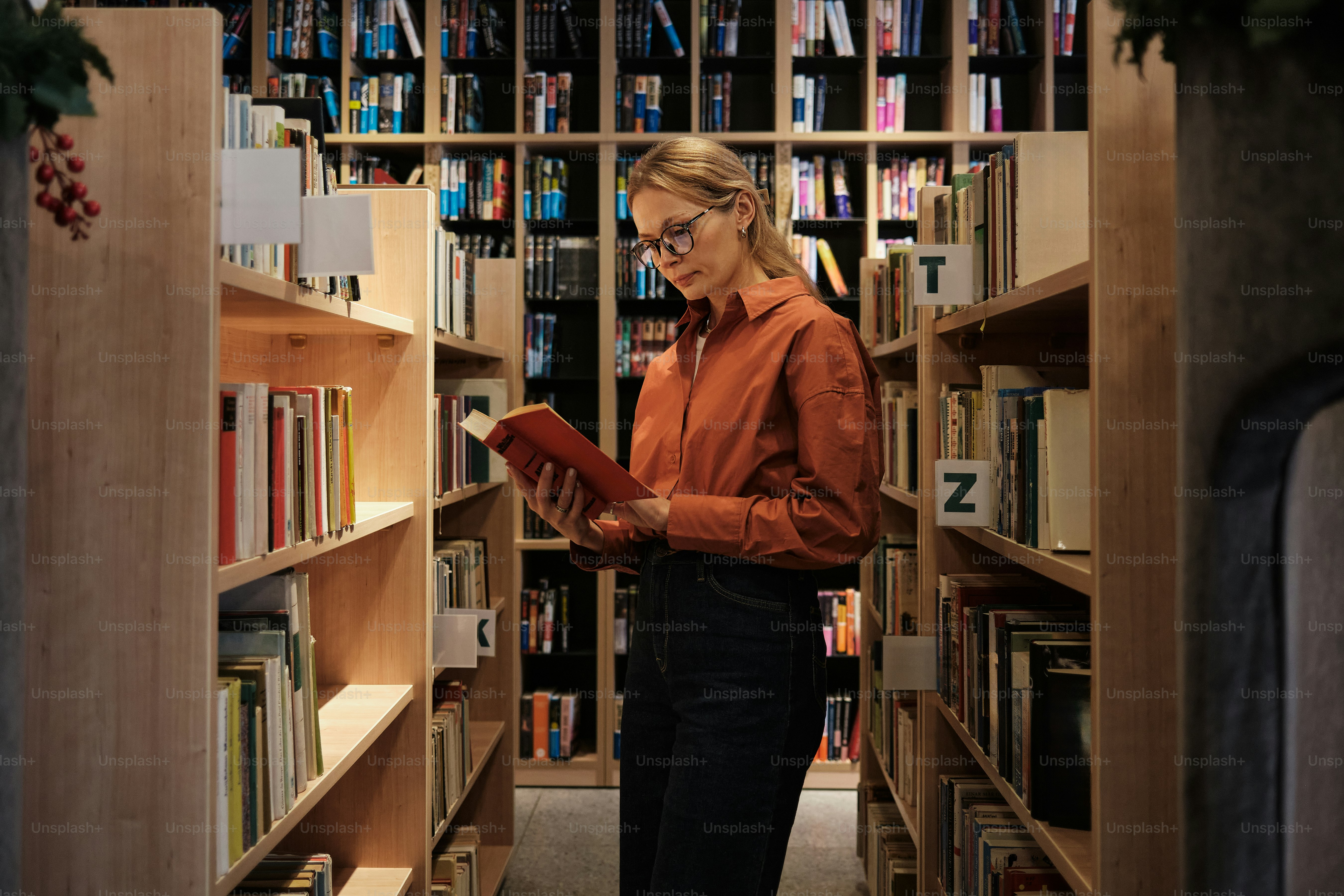 Woman reading a book in a library