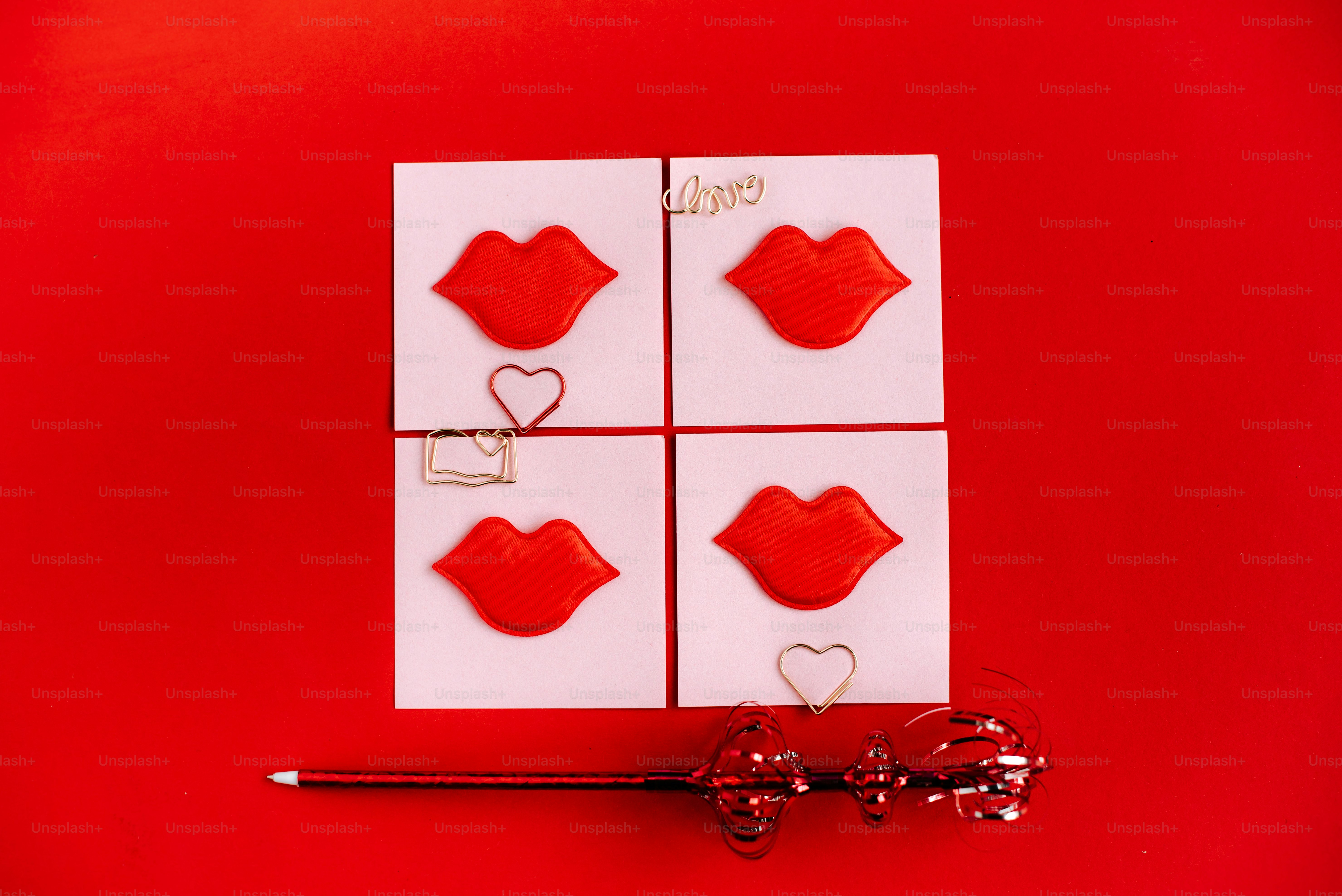 Four red lips on white squares with hearts