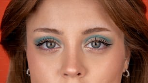 a close up of a woman with blue eyes