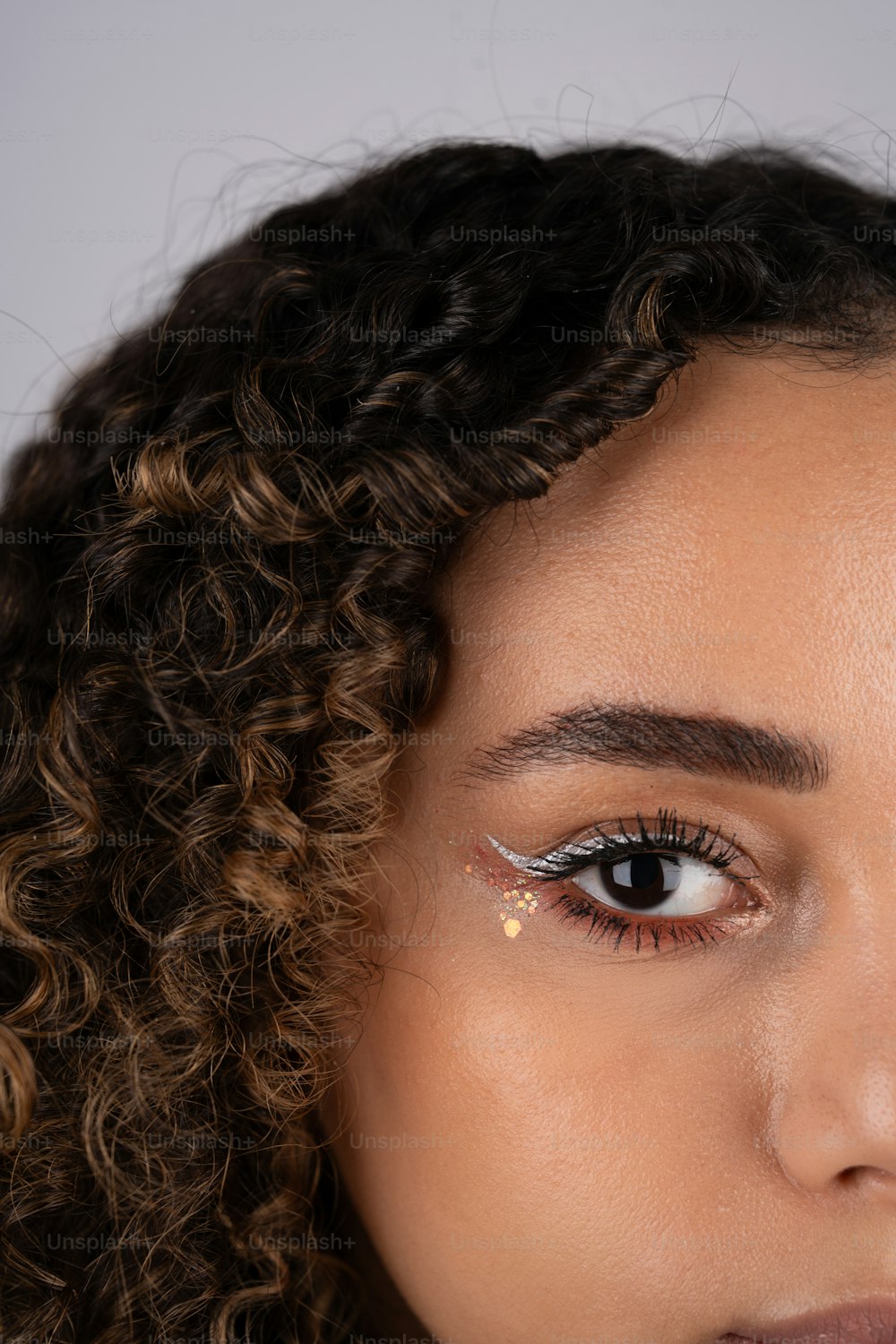 a close up of a woman with long curly hair