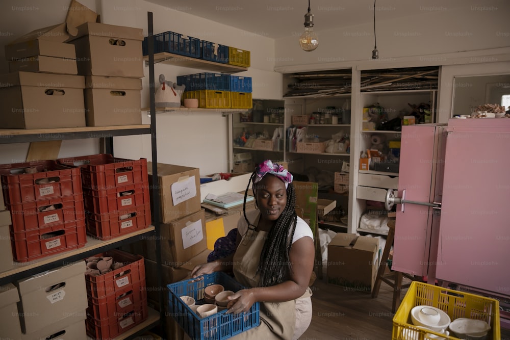 a woman standing in a room filled with boxes