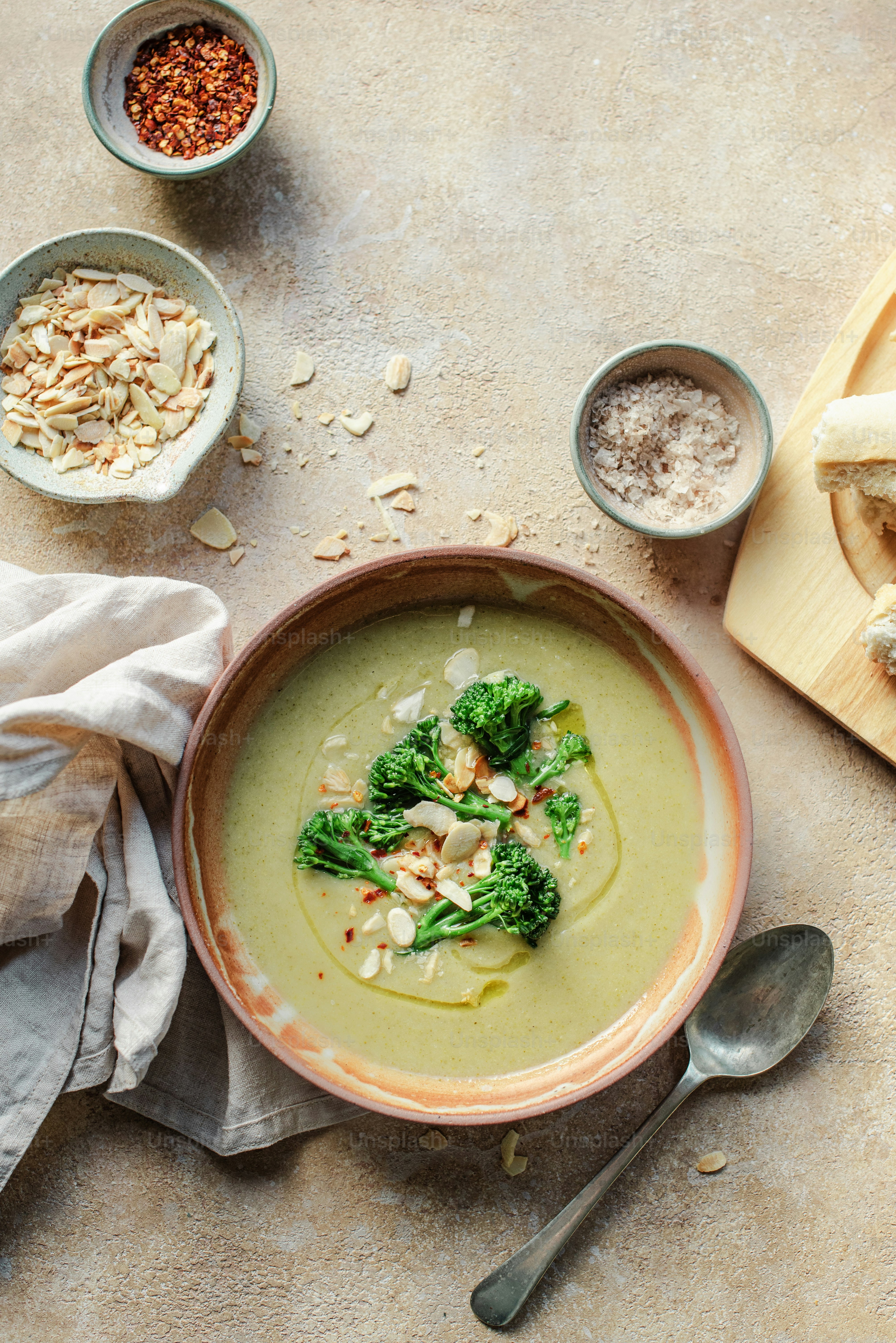a bowl of broccoli soup on a table