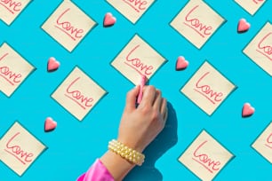 a person writing love on sticky notes