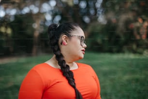 a woman with glasses standing in a field