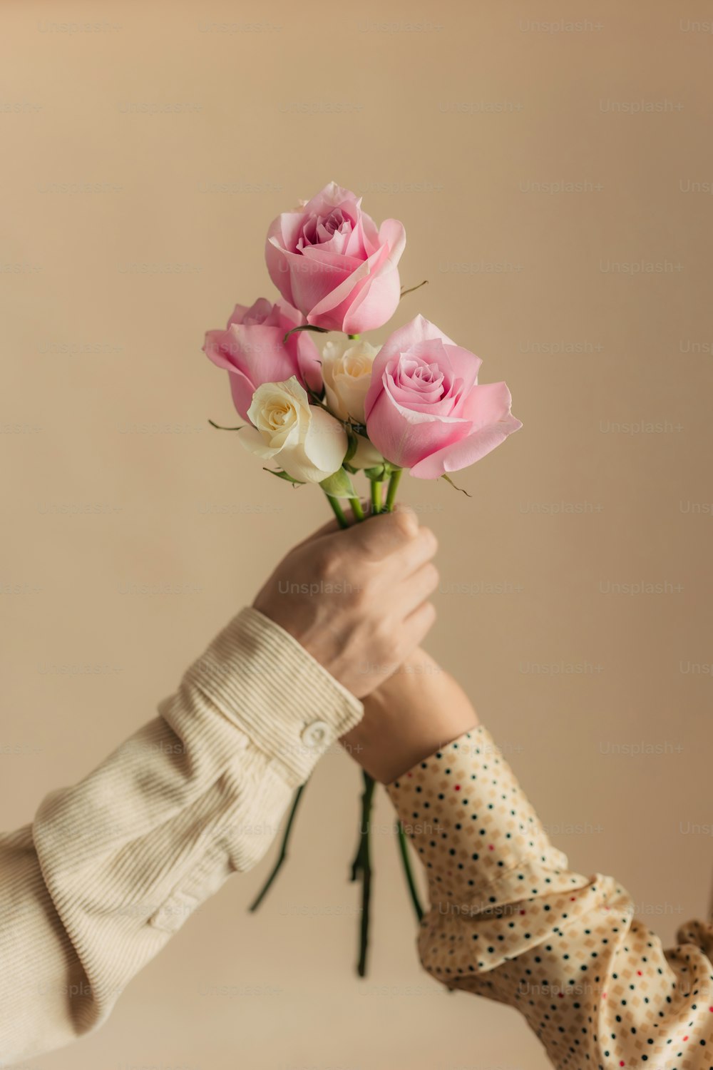 une personne tenant un bouquet de roses roses