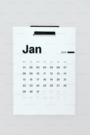 a calendar pinned to a white wall with the date jan on it