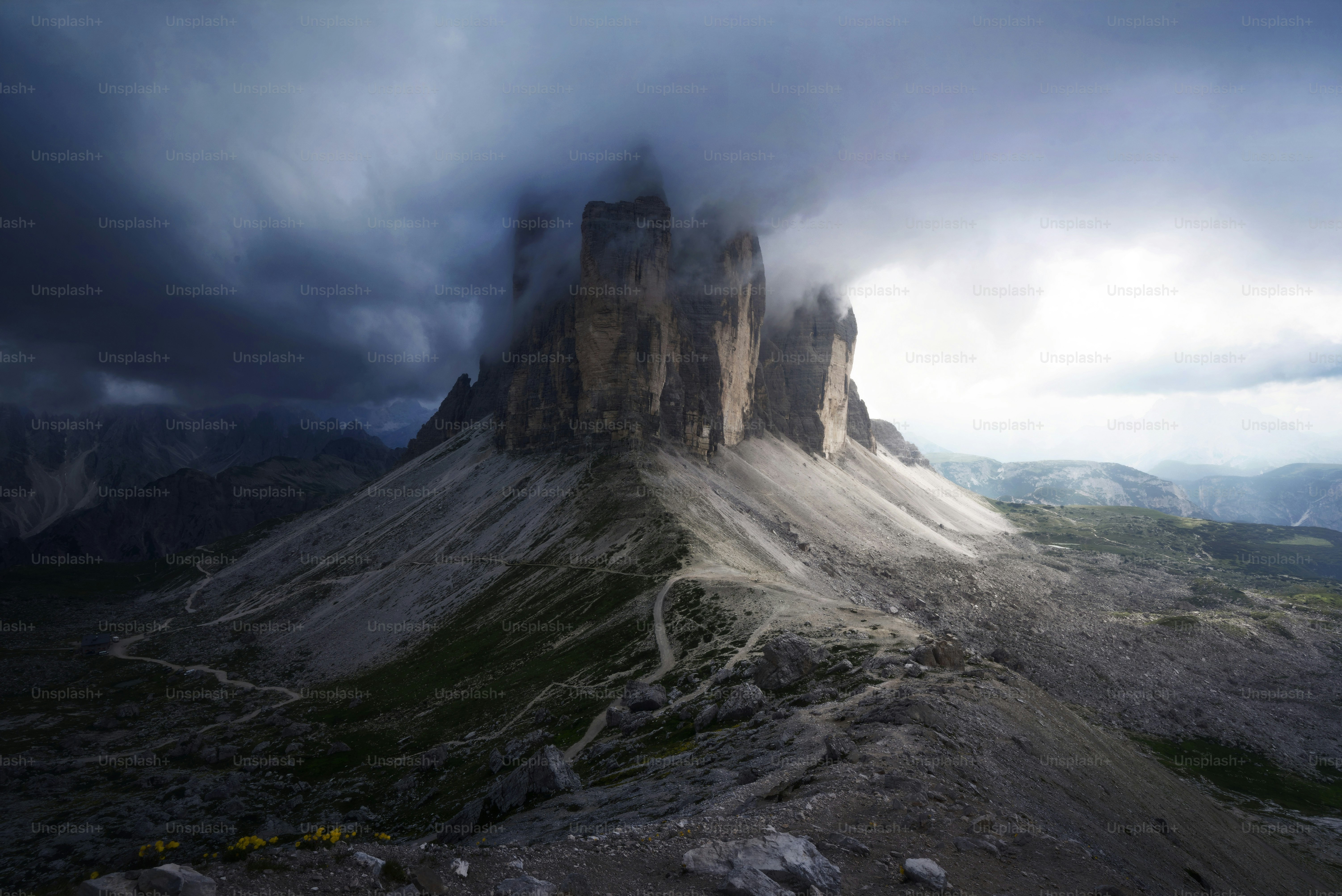 a very tall mountain with a very cloudy sky