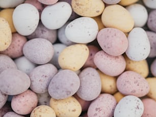 a close up of a pile of candy eggs