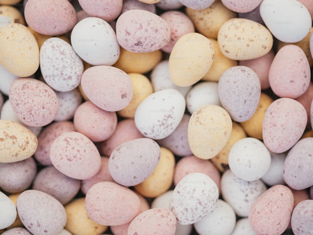 a close up of a pile of candy eggs