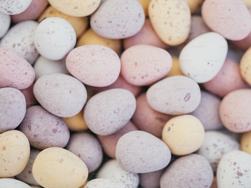 a close up of a pile of candy eggs
