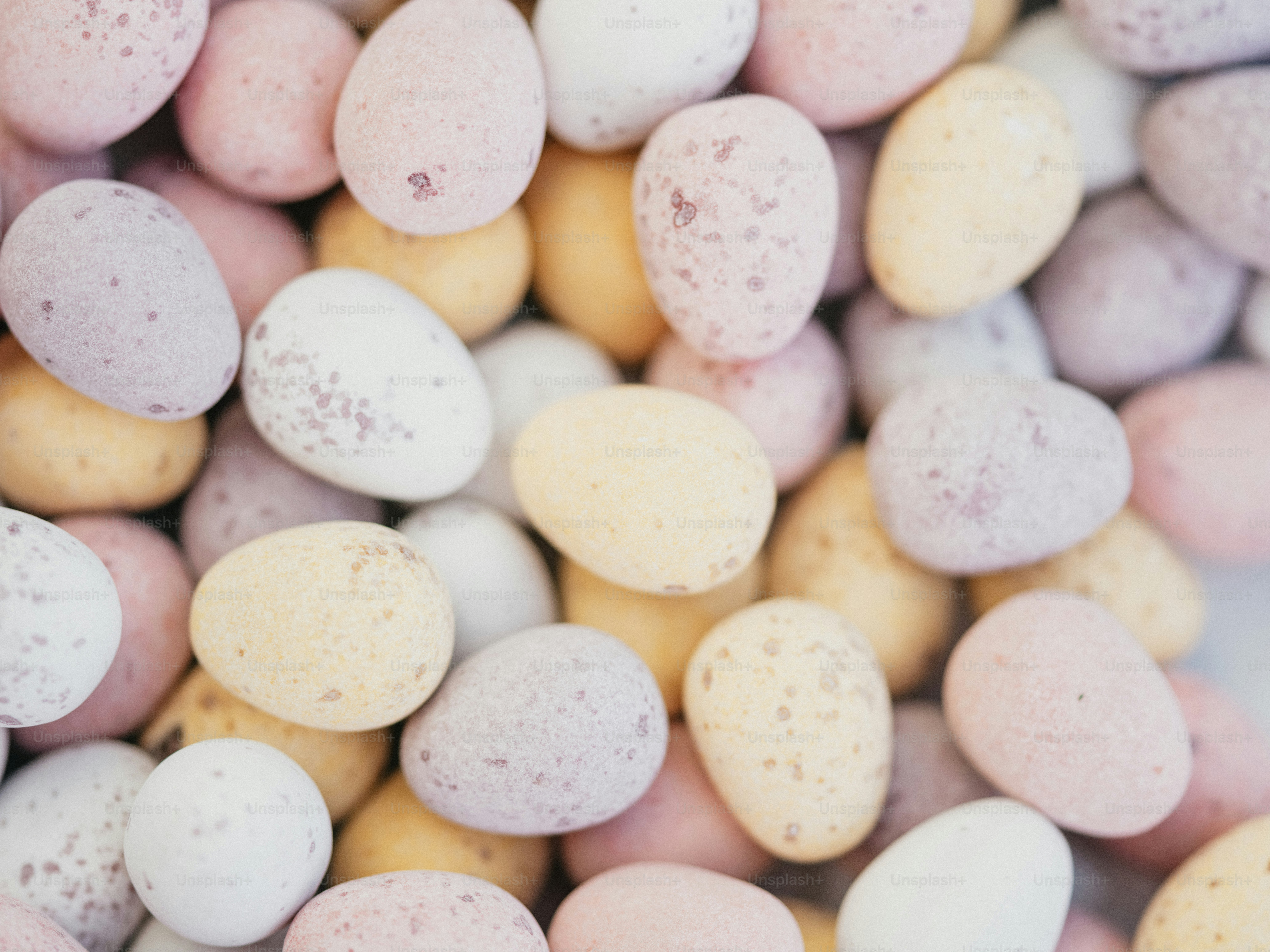 a close up of a pile of candy eggs