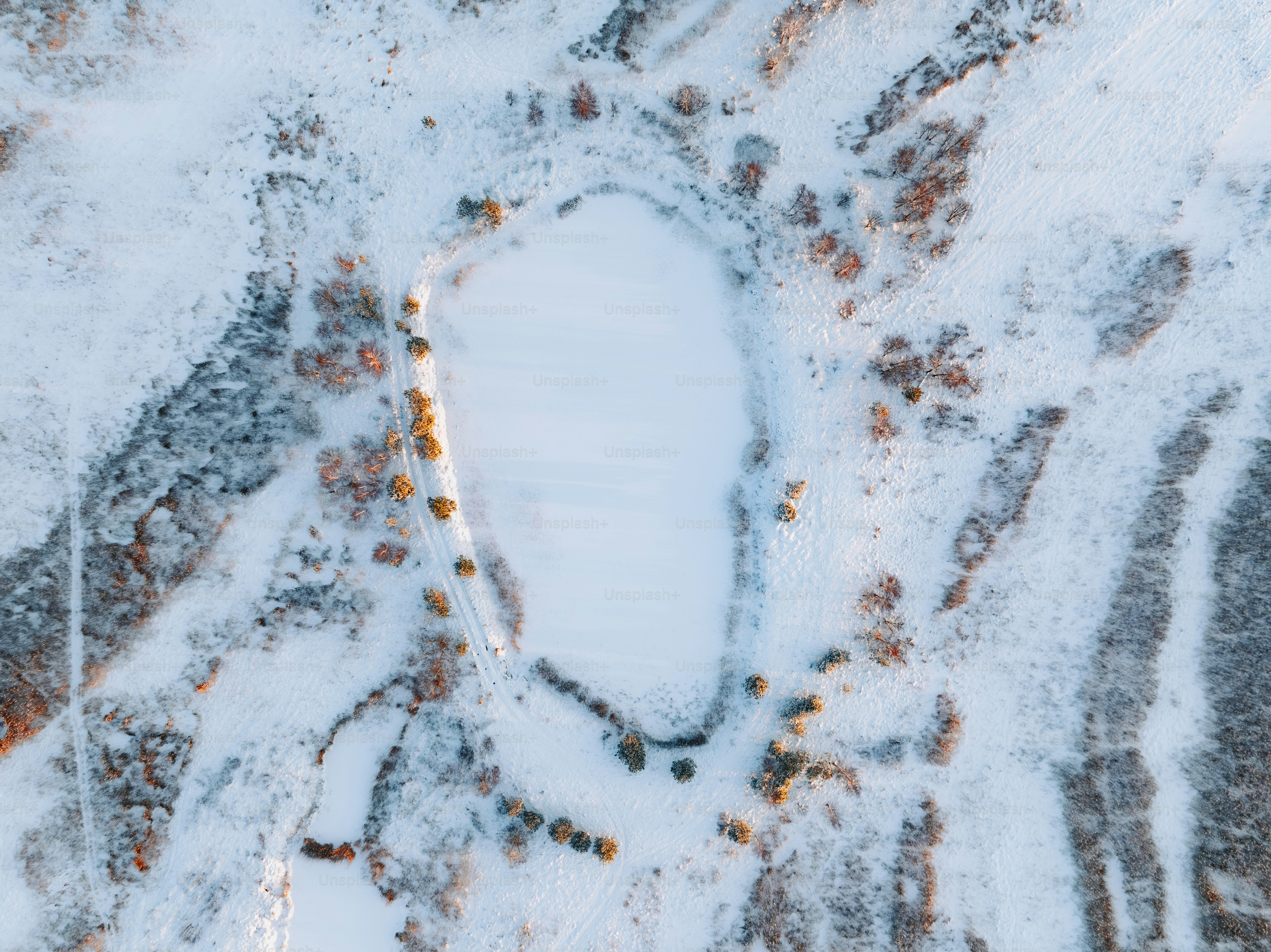 an aerial view of a snow covered landscape