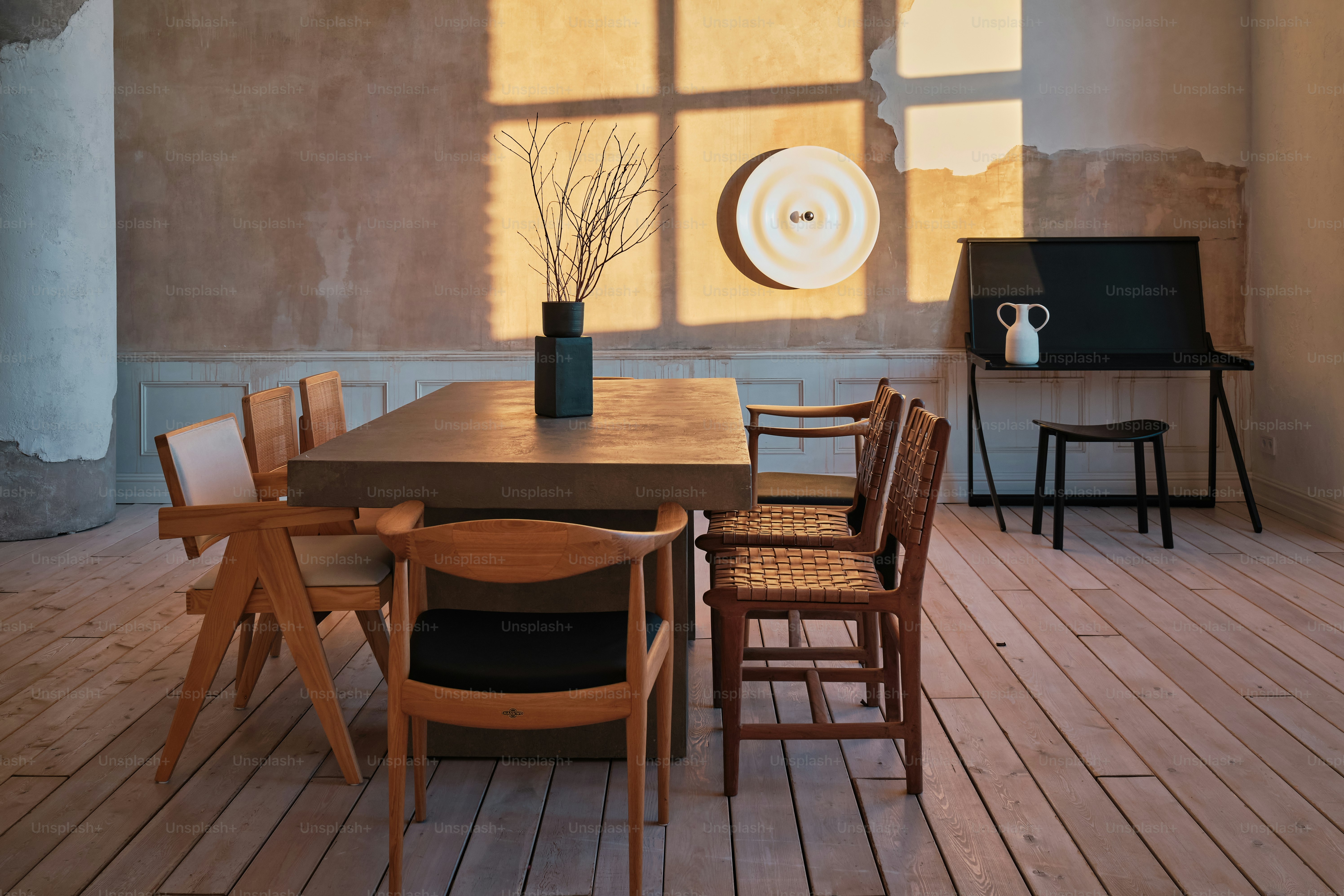a room with a table, chairs and a television