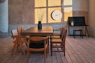 a room with a table, chairs and a television