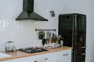 a black refrigerator freezer sitting inside of a kitchen