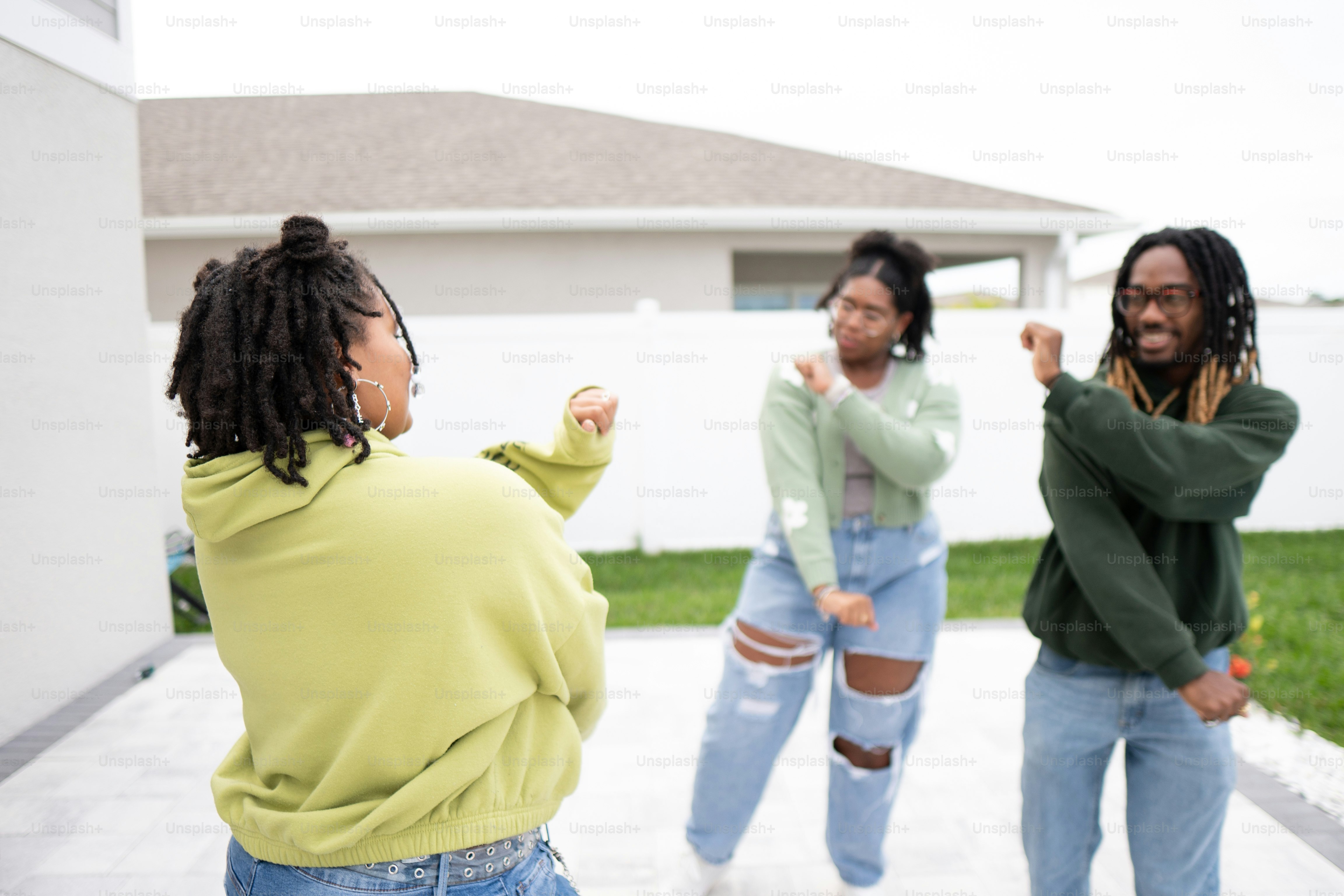 a group of people standing outside of a house