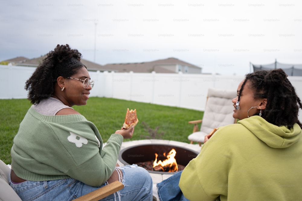 a couple of women sitting next to each other