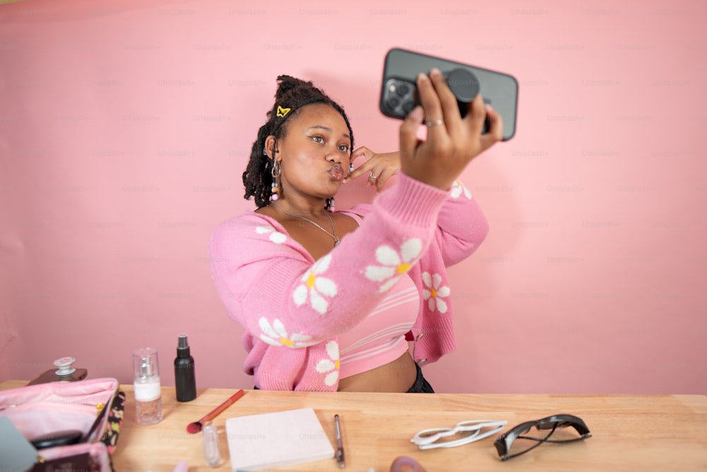 a woman taking a picture of herself in a mirror