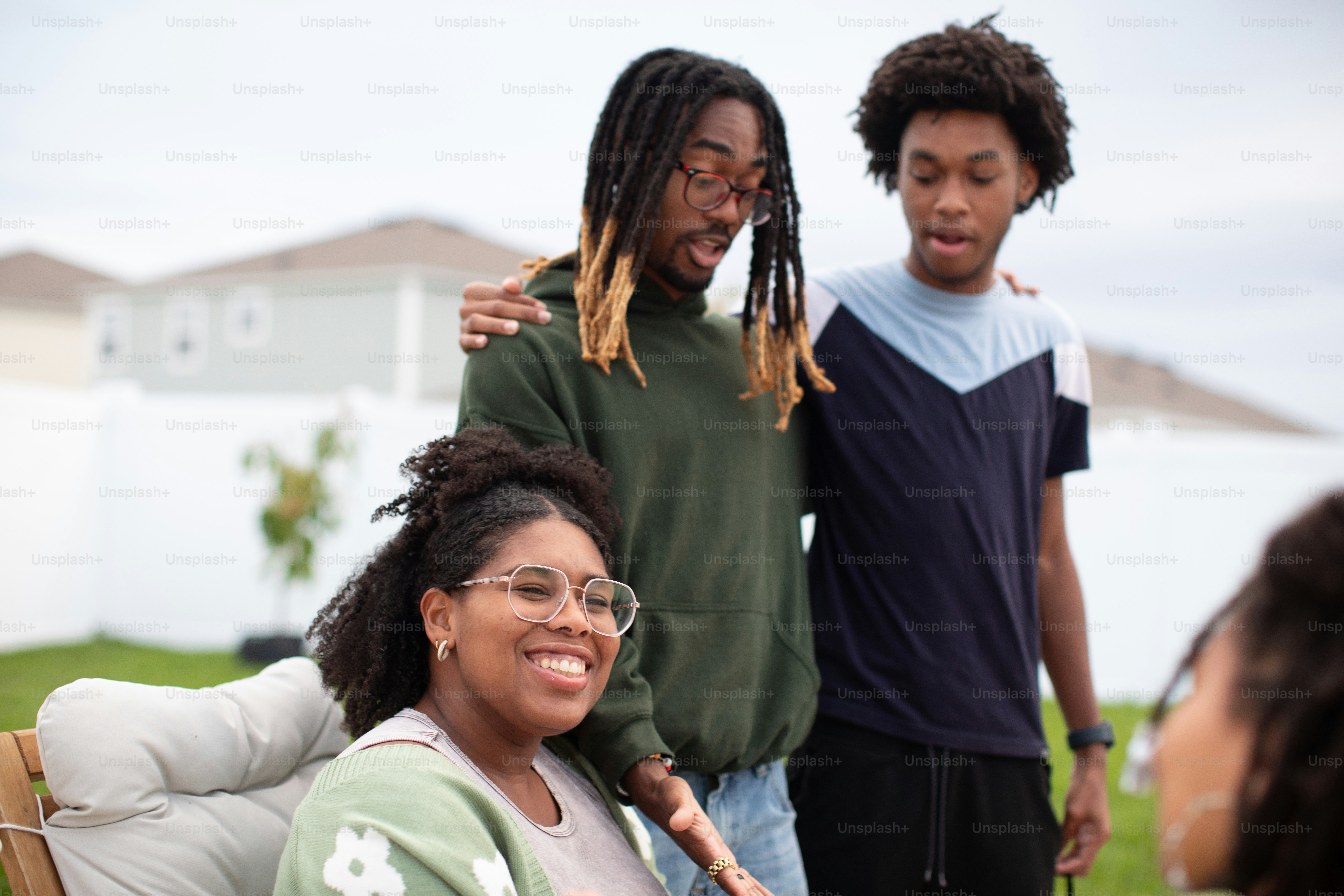 a group of young people standing around a table