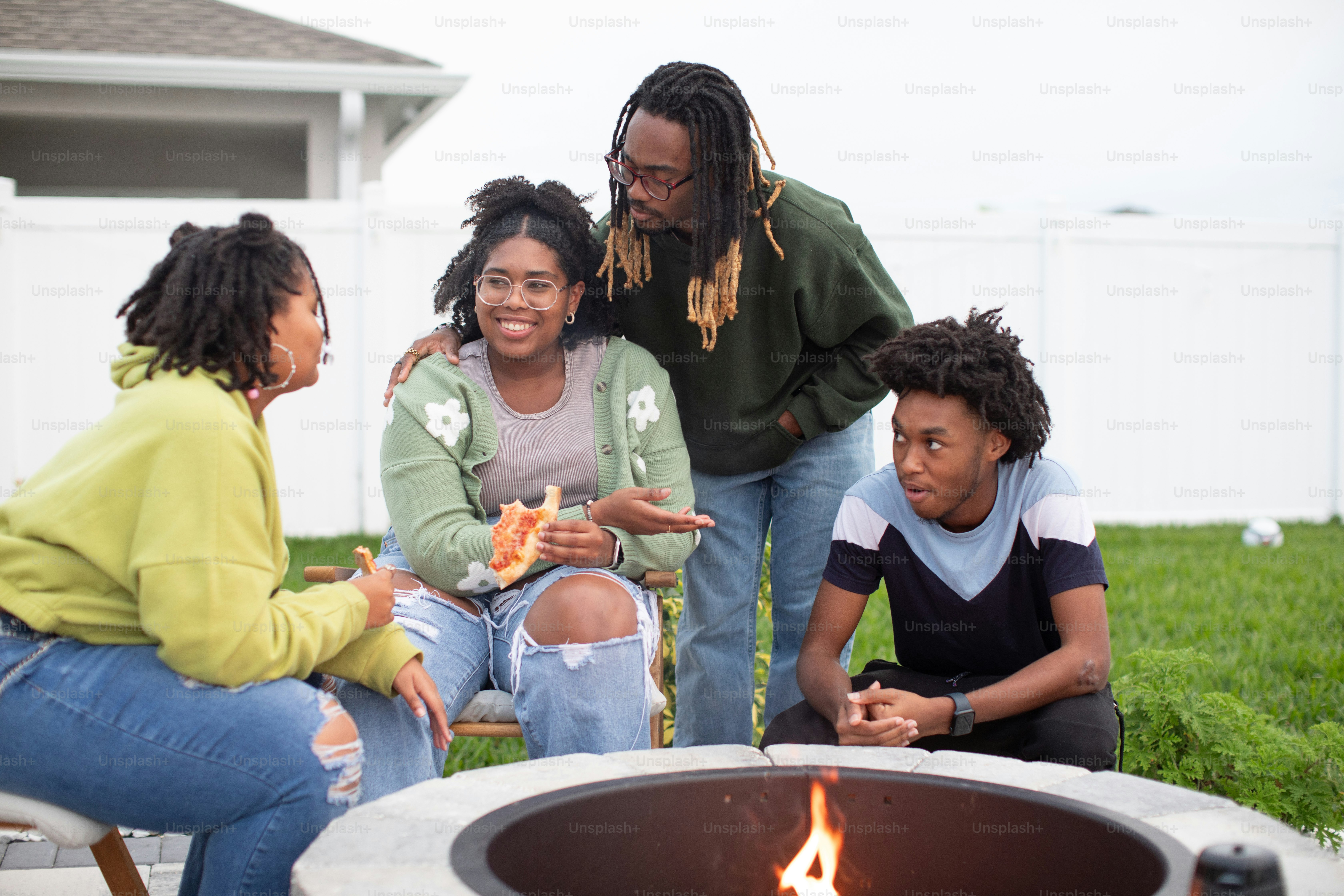 a group of people sitting around a fire pit