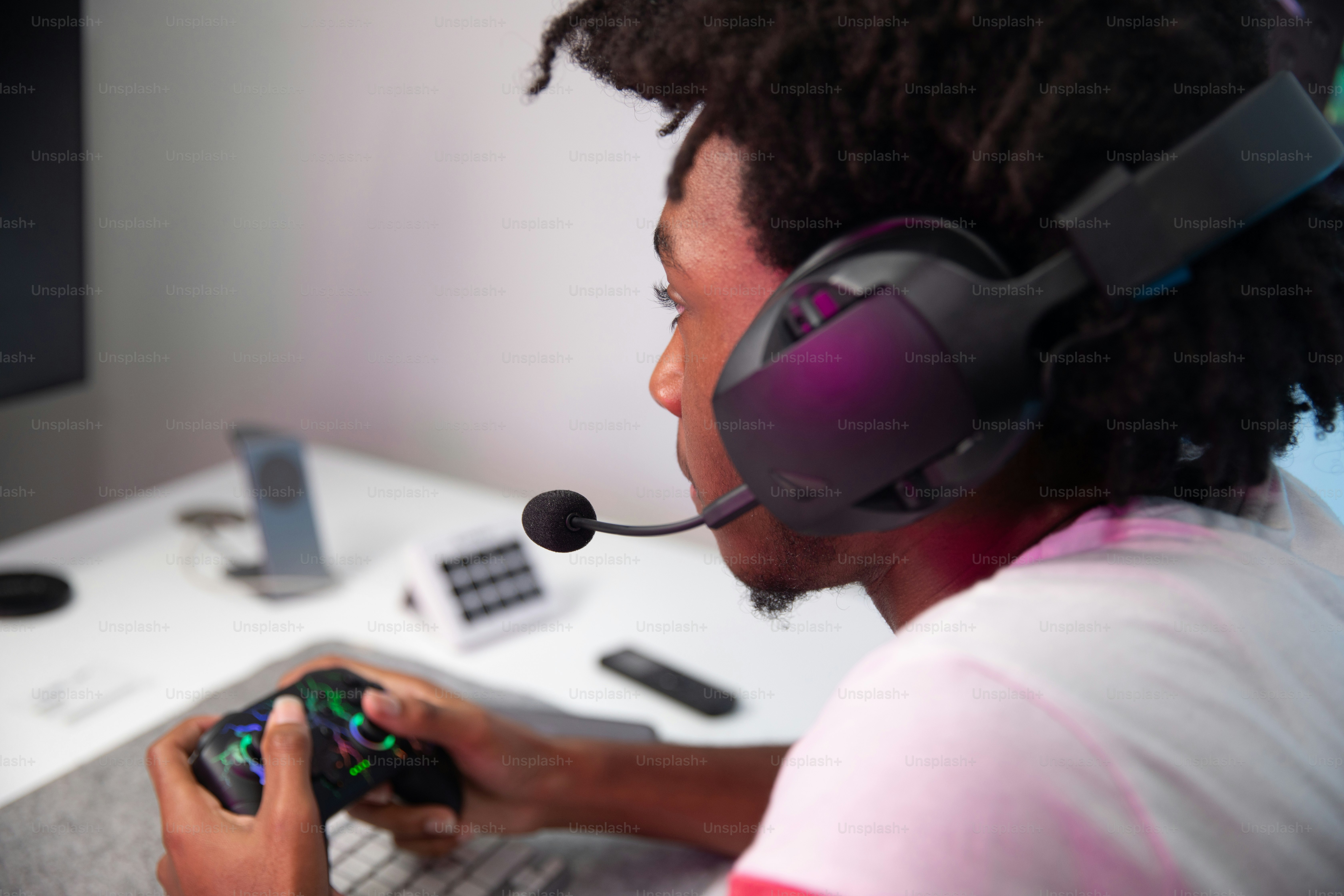 A man wearing a headset playing a video game photo – Game night Image ...