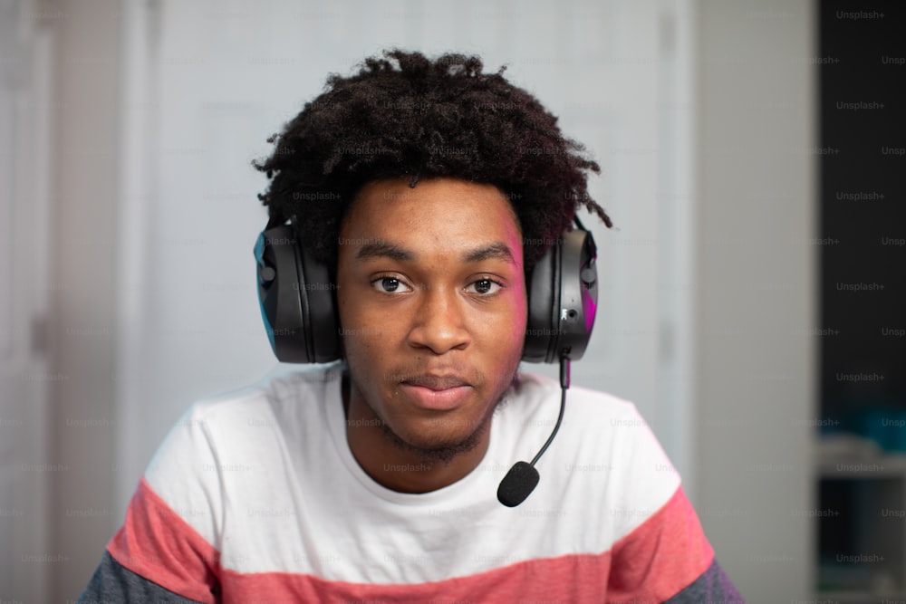 a young man wearing headphones and a red and white shirt