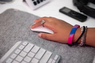 a woman's hand with a ring on a mouse pad