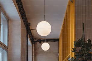 a couple of white lights hanging from a ceiling