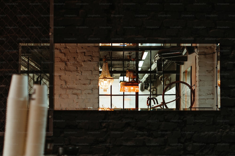 a mirror reflecting a room with a brick wall