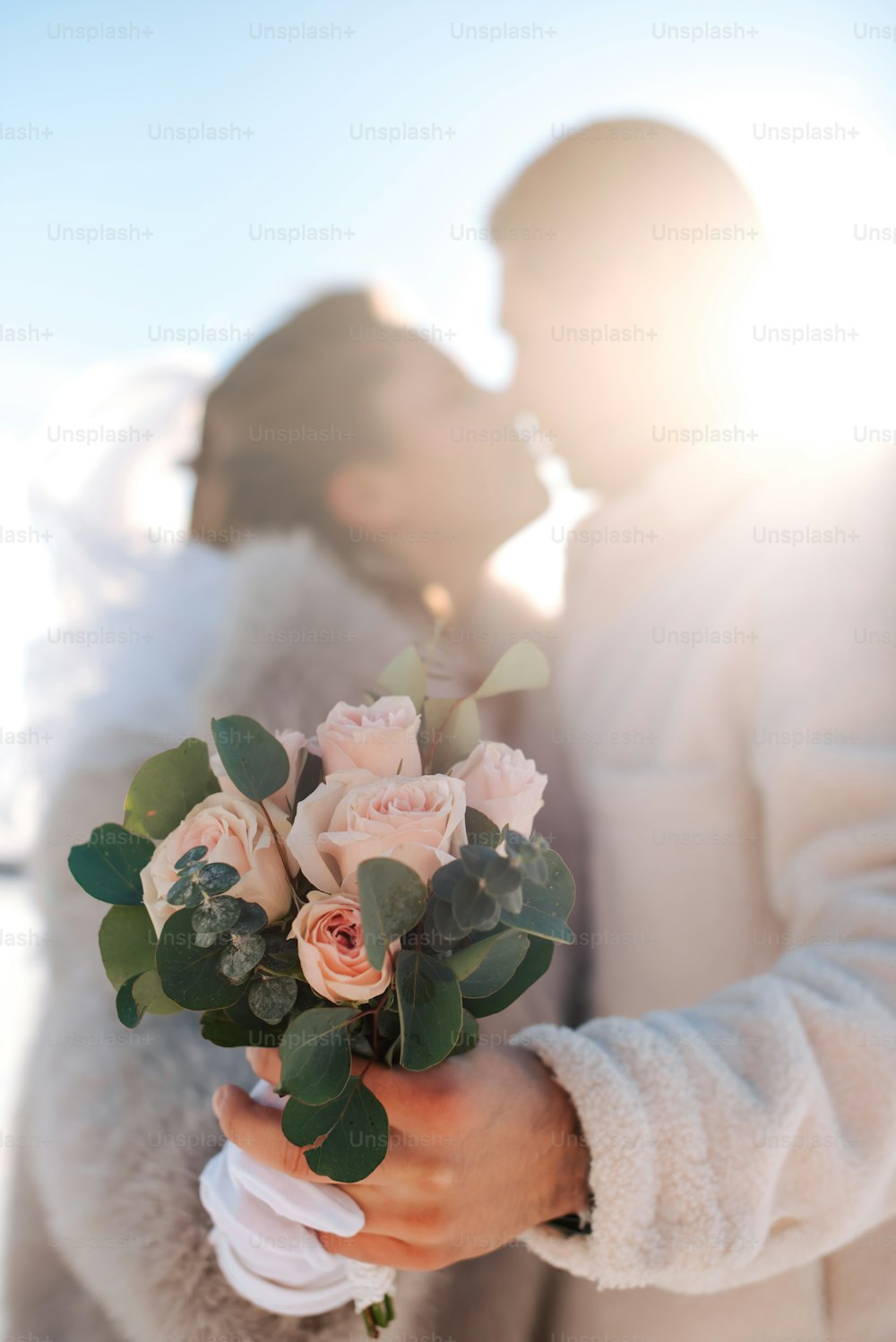 a man and a woman holding a bouquet of flowers