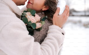 a man and a woman embracing each other in the snow