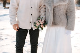 a man and a woman standing next to each other in the snow