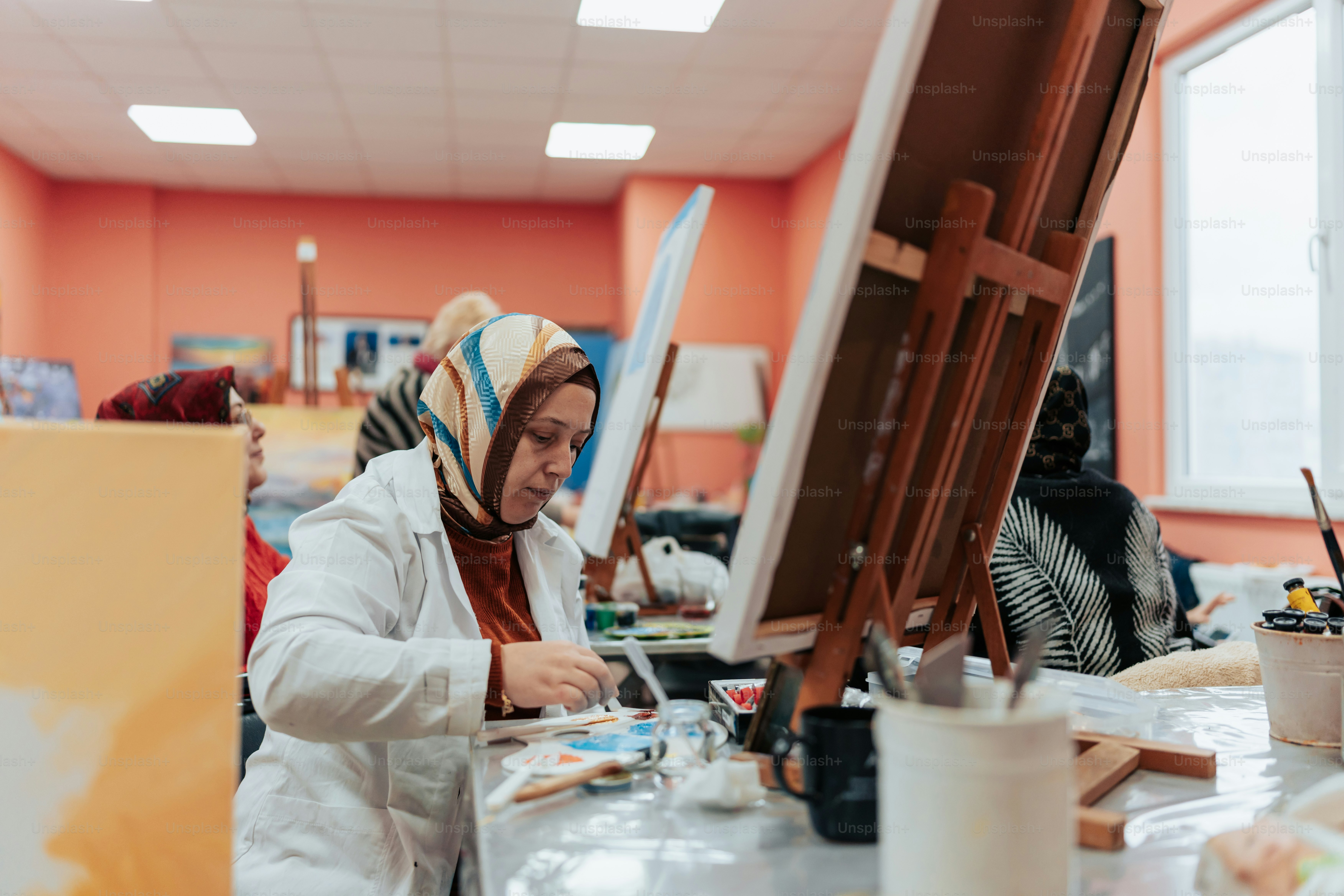 A woman is painting in an art class photo – Painting Image on Unsplash