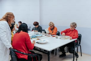 a group of people sitting around a table eating food