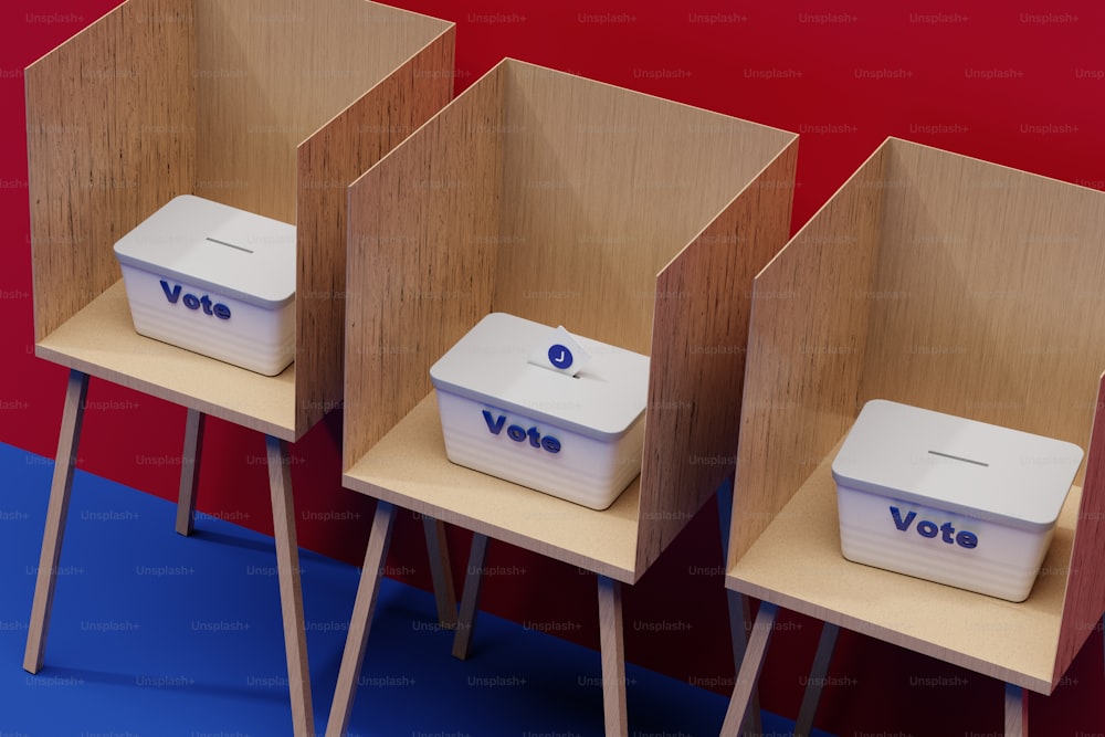 drei Holzstühle mit Wahlurnen darauf