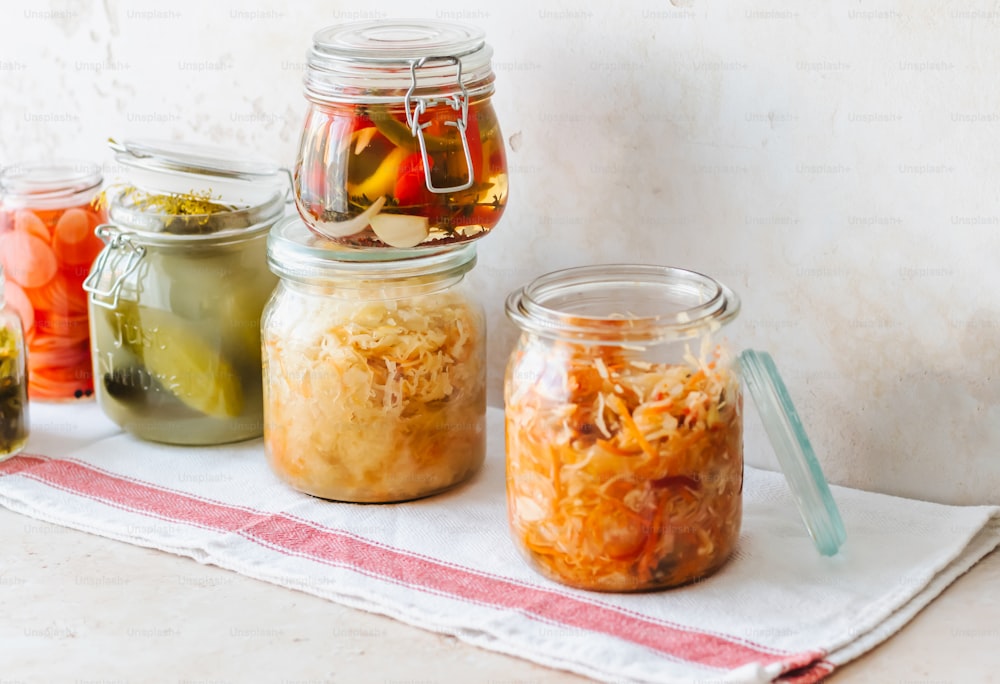 a table topped with jars filled with food