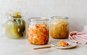 a table topped with jars filled with food