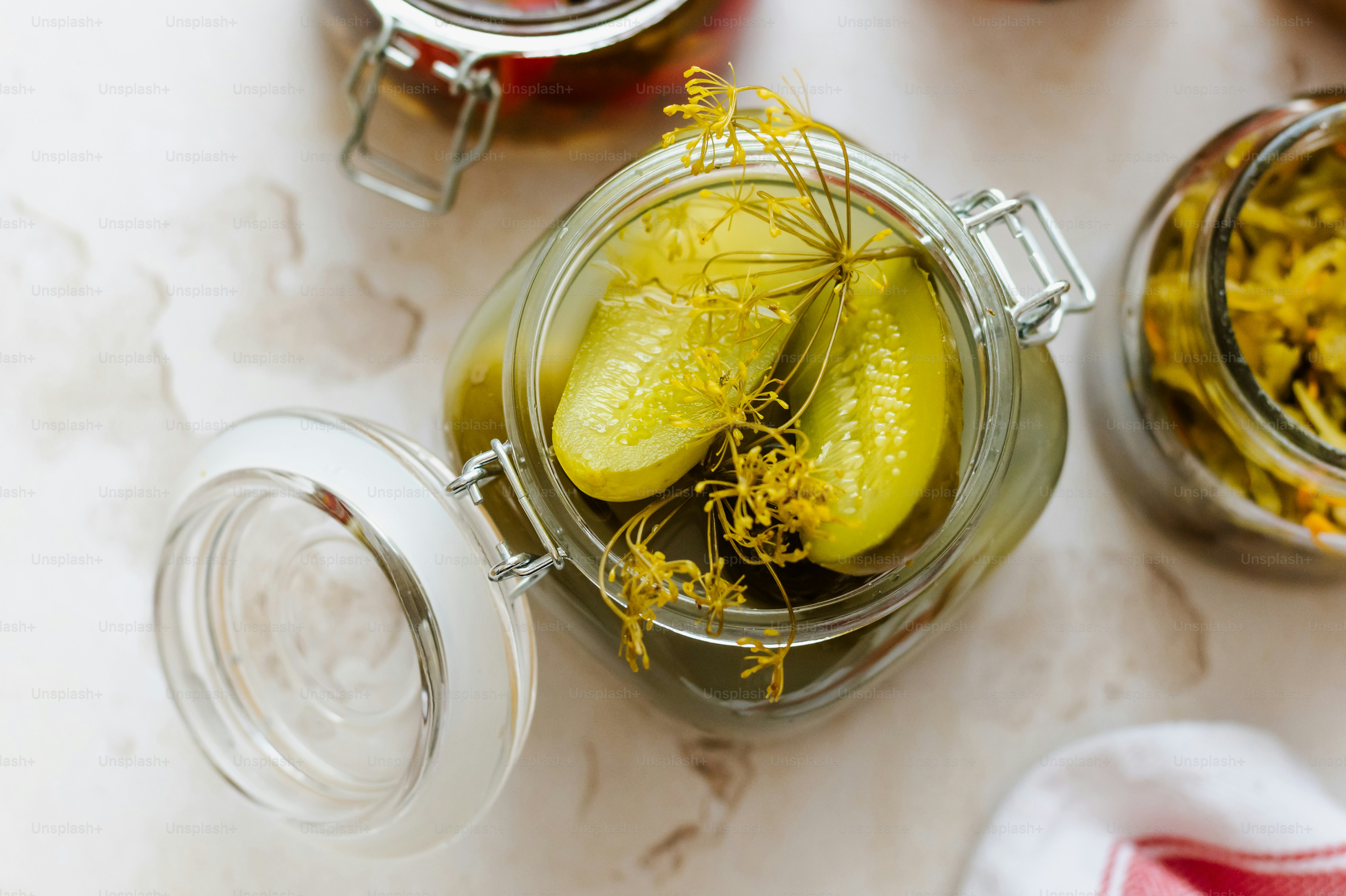 a jar filled with pickles sitting on top of a table