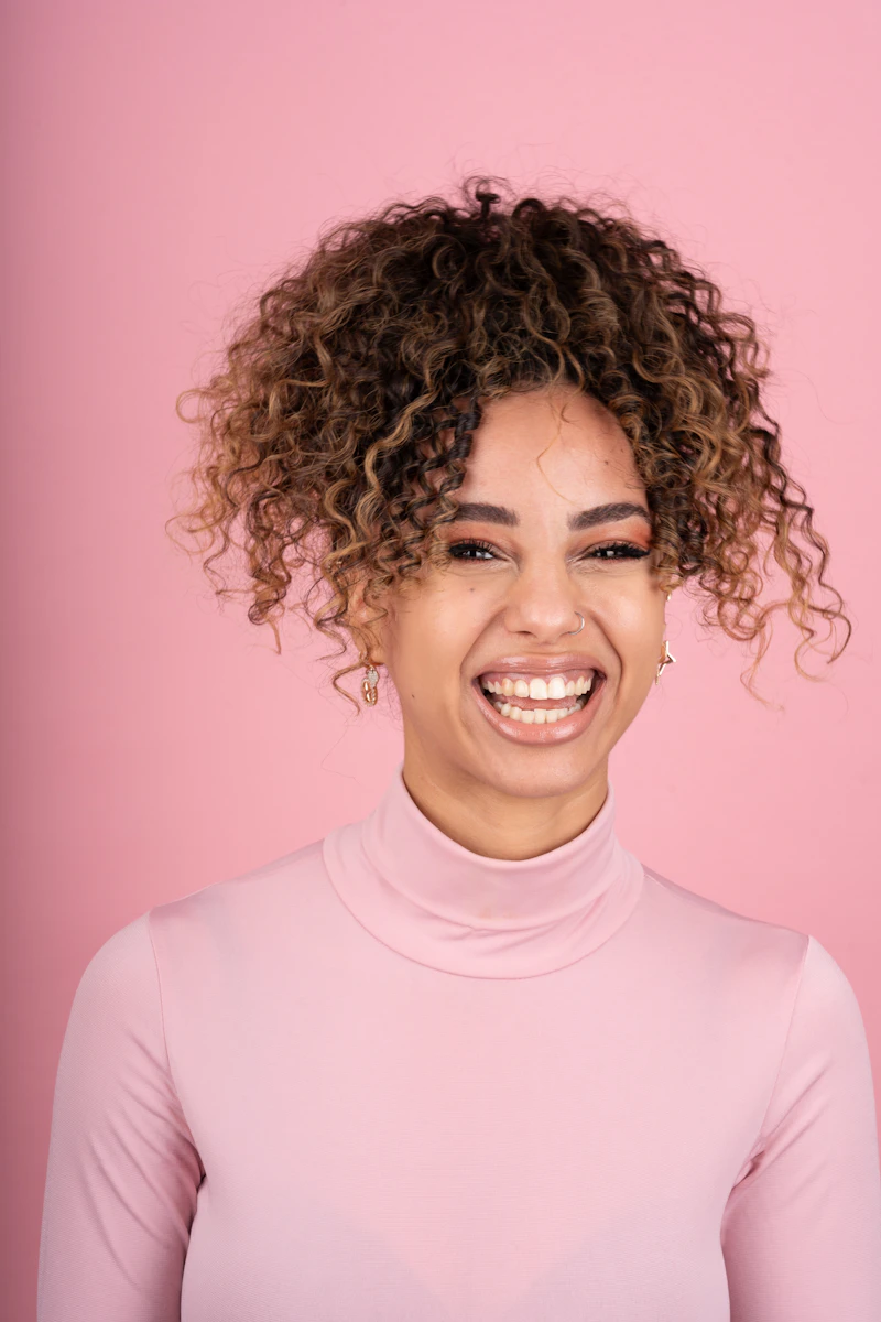 Happy woman with natural curly hair outdoors