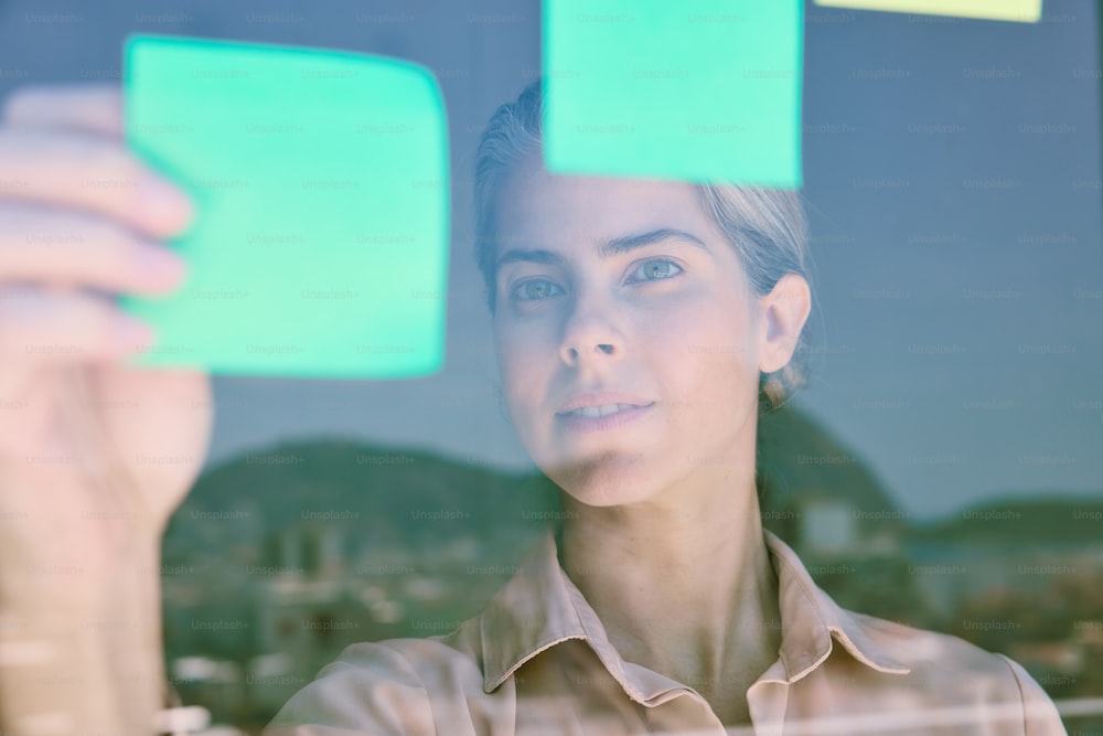 a woman holding up a piece of paper in front of her face