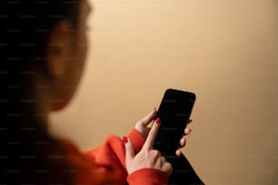 a woman holding a cell phone in her hand