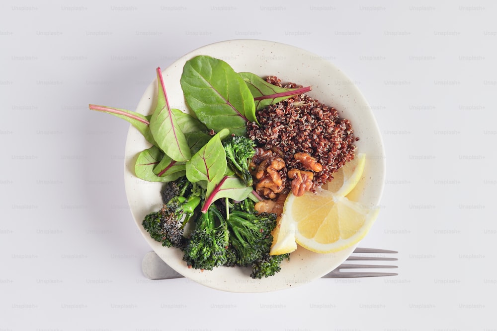 a white plate topped with broccoli and other vegetables