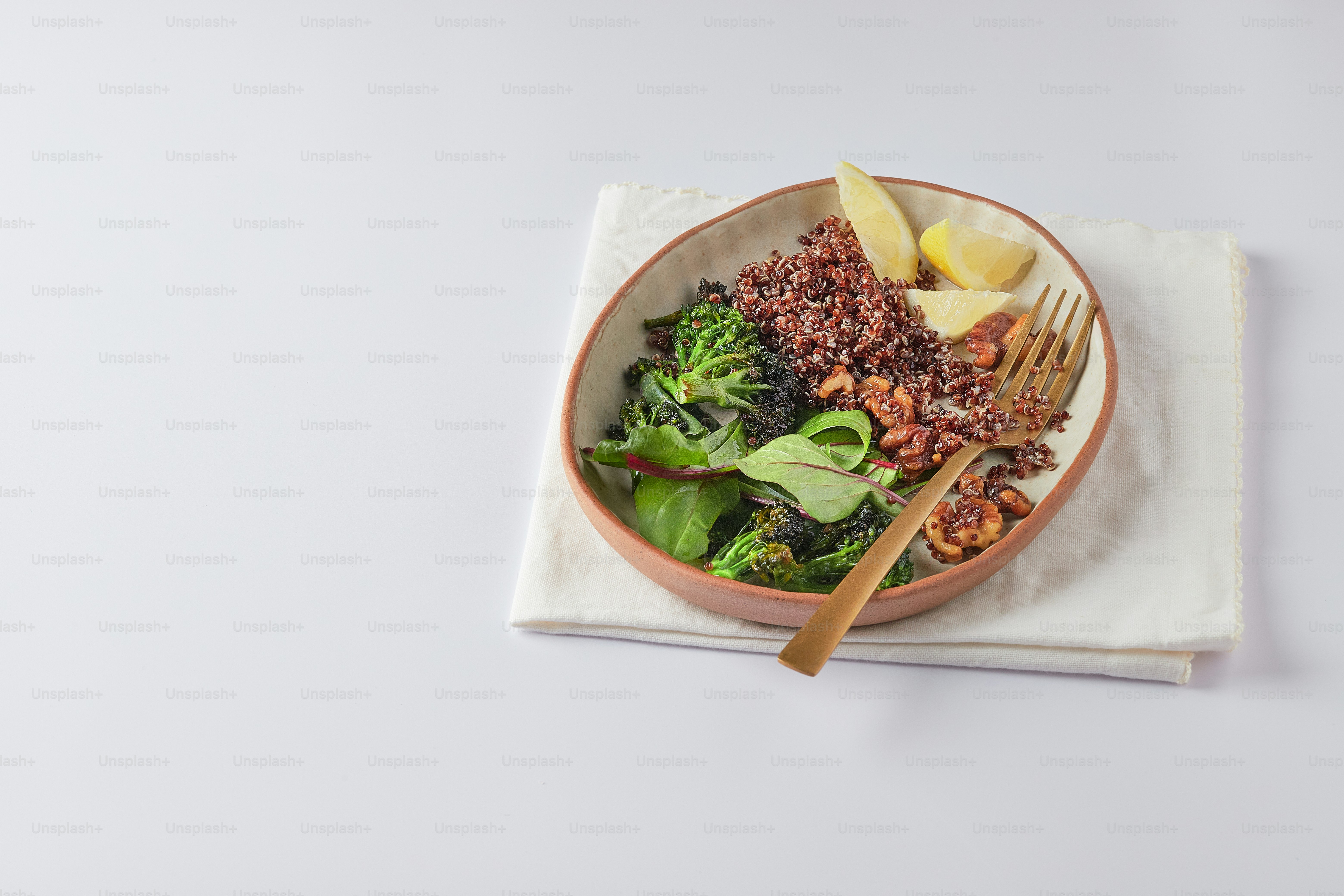 a bowl of food with a fork and a napkin