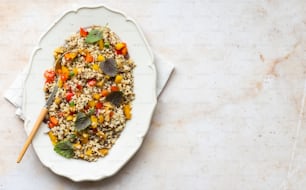 a white plate topped with rice and vegetables