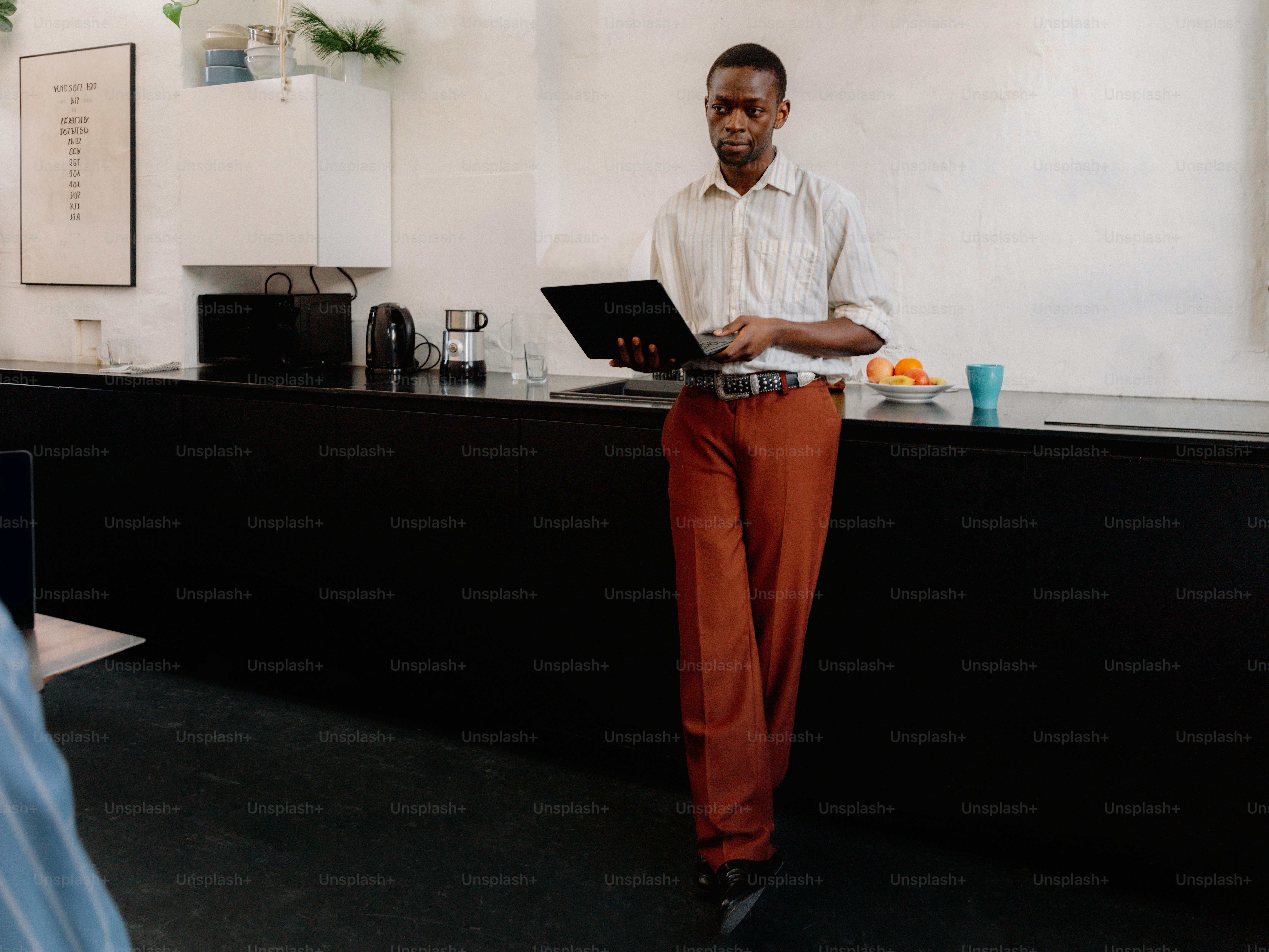 a man standing in front of a laptop computer