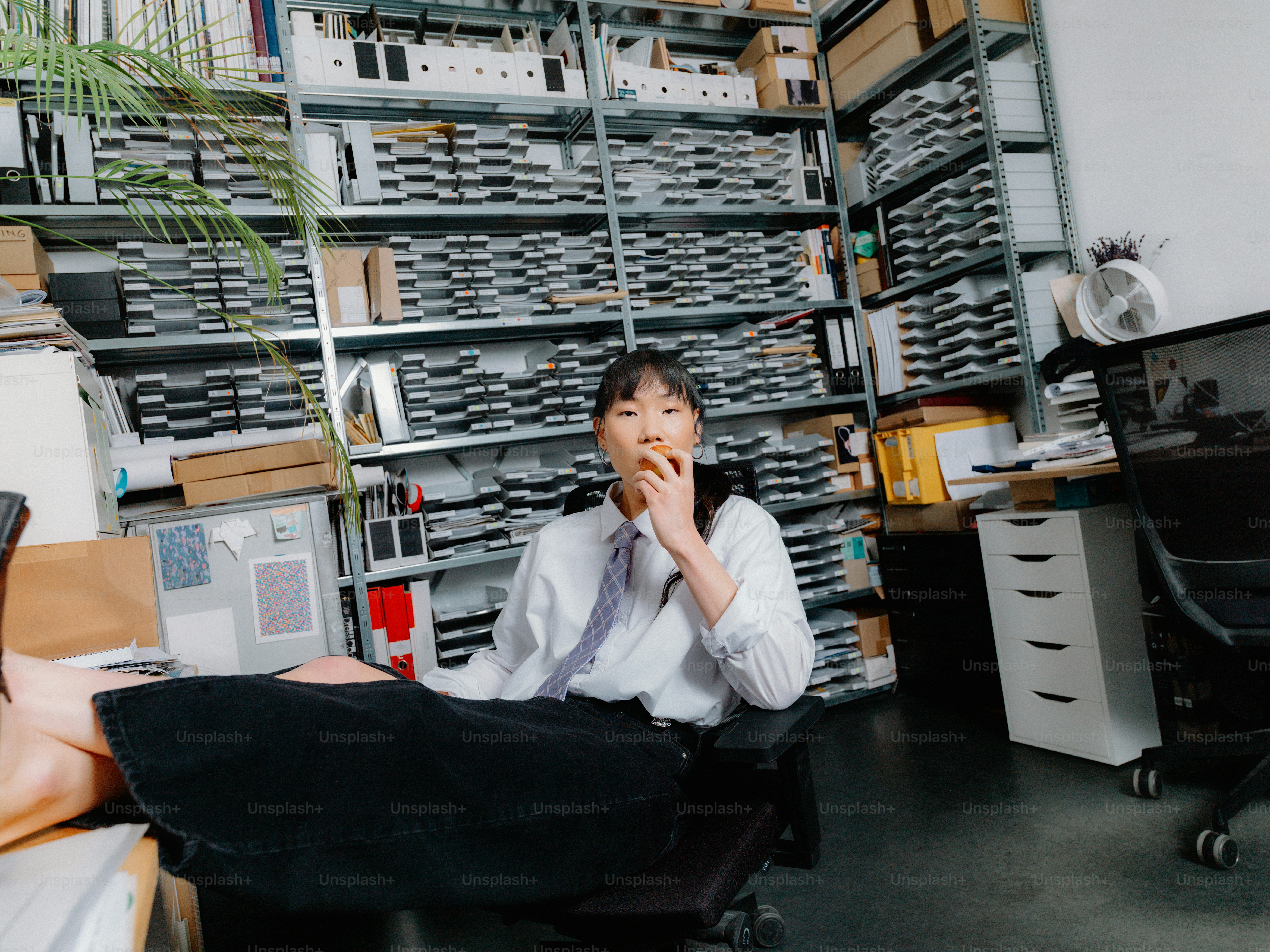 a man sitting in a chair in front of a desk