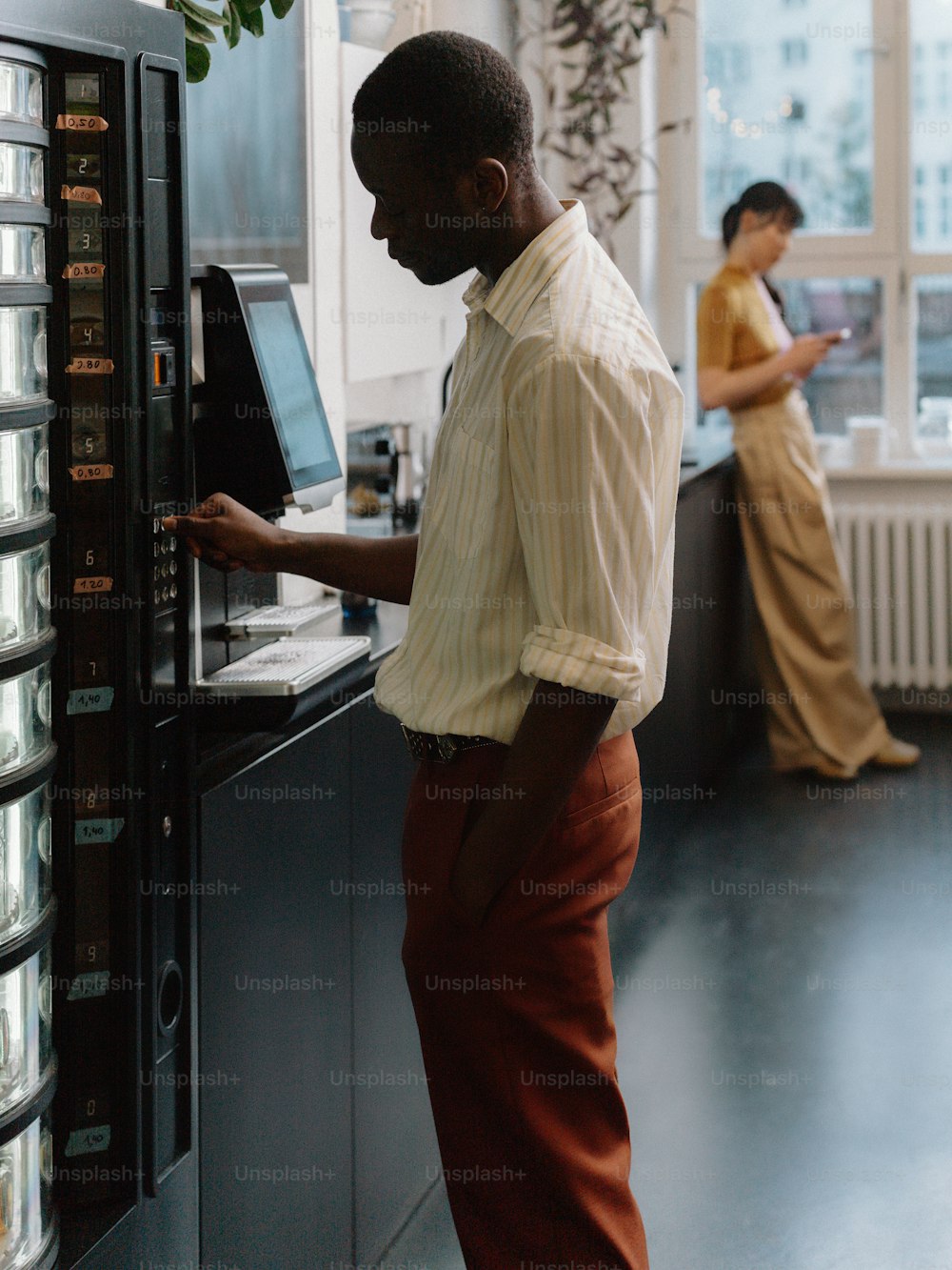 a man standing in front of a server in a kitchen