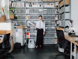 a woman standing in front of a book shelf filled with books