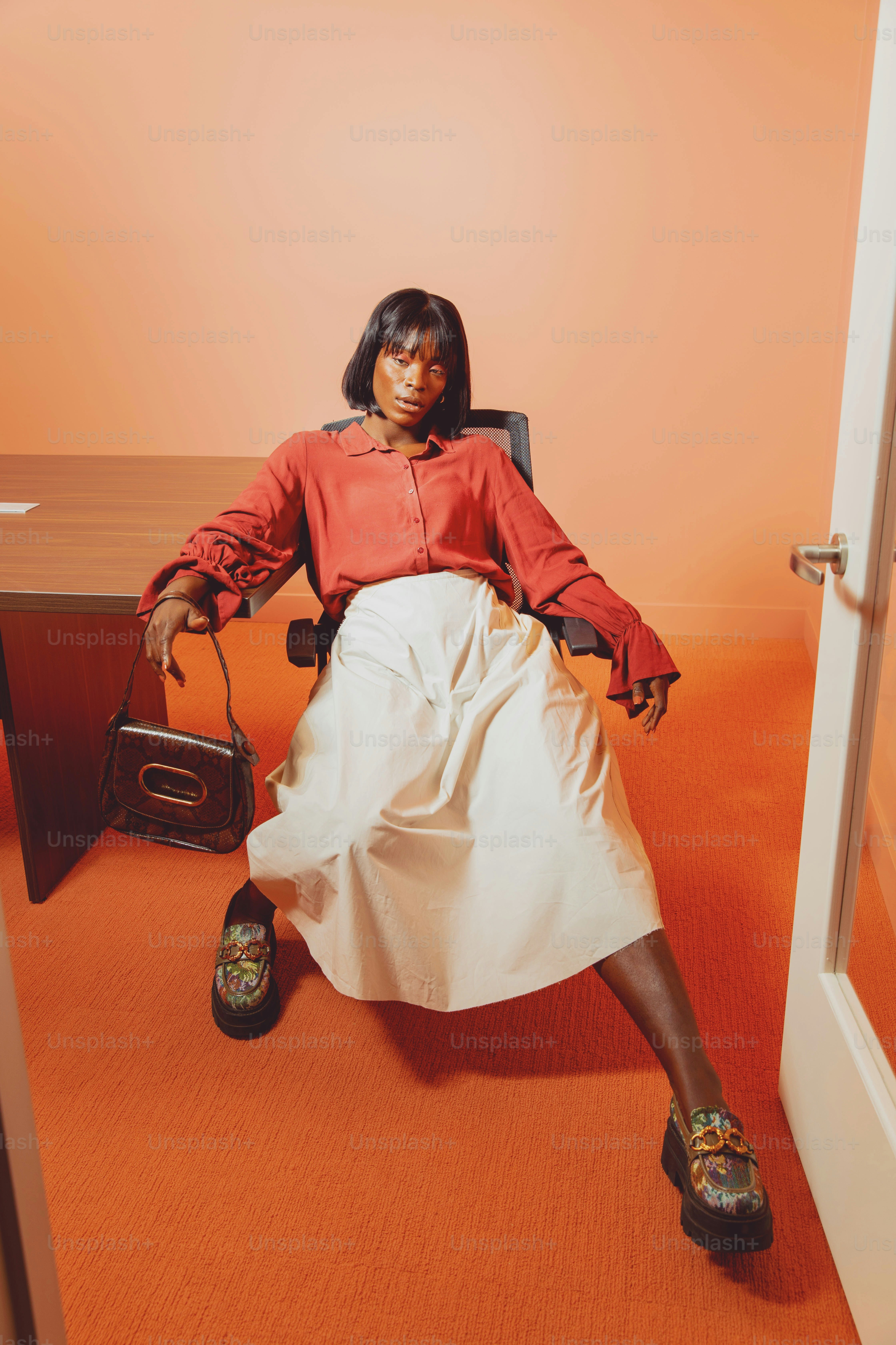 a woman sitting in a chair with a purse