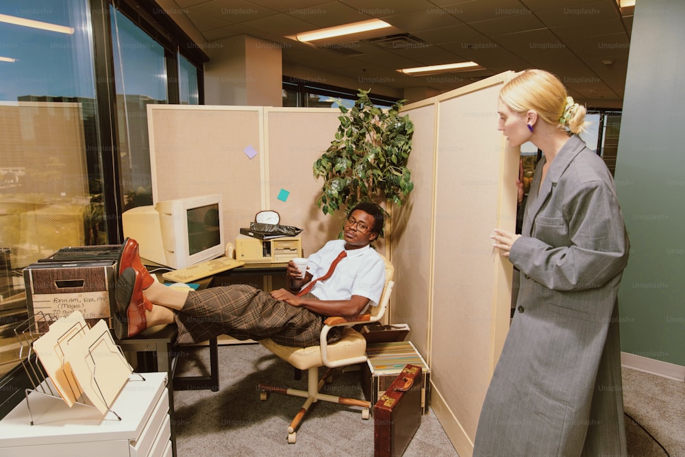 a woman standing next to a man in an office